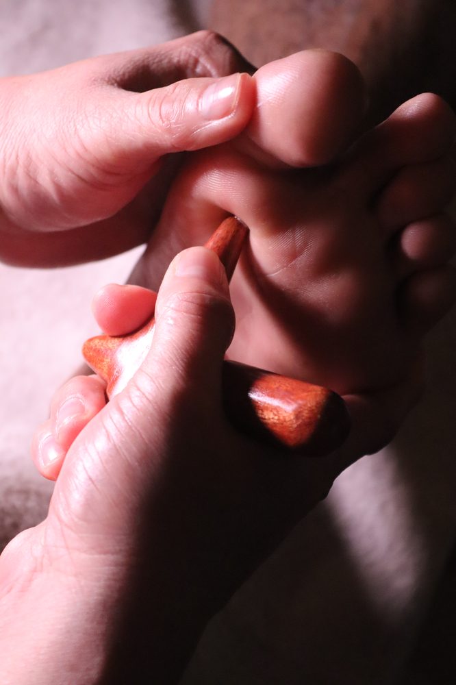 Foot massage with wooden tool at The One Men Foot Care